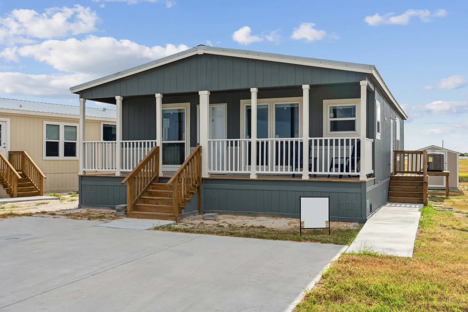 Finished manufactured home exterior with skirted, enclosed base