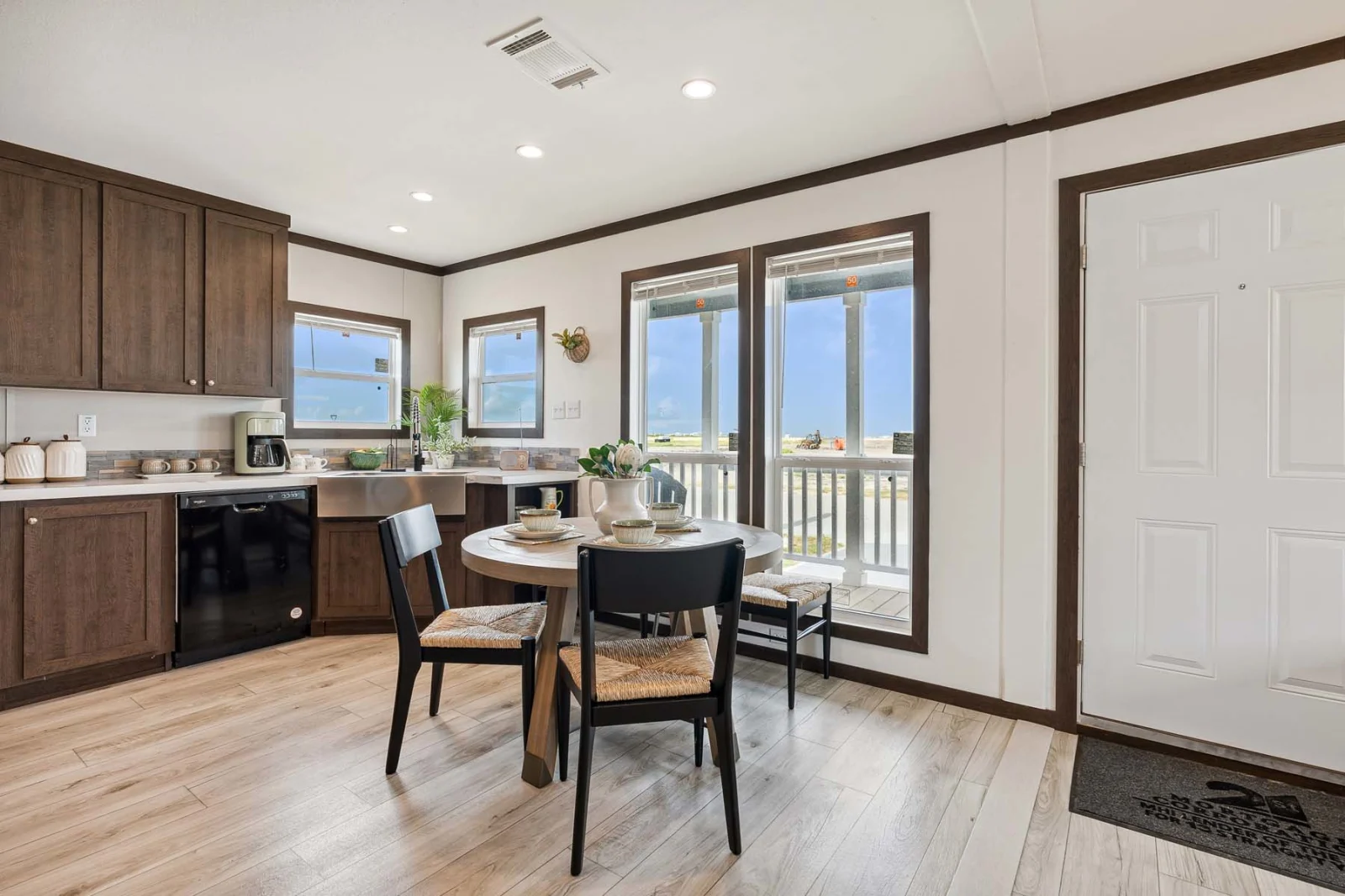 Bright dining area with a round table and chairs in The Rado tiny home