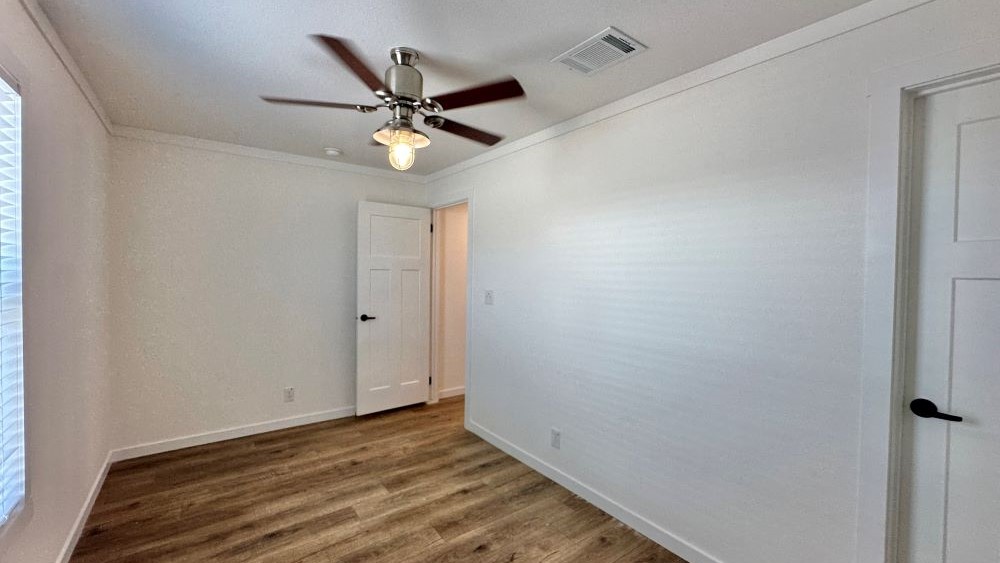 View down interior hallway toward kitchen area in Tiny Homes USA Stealth model.