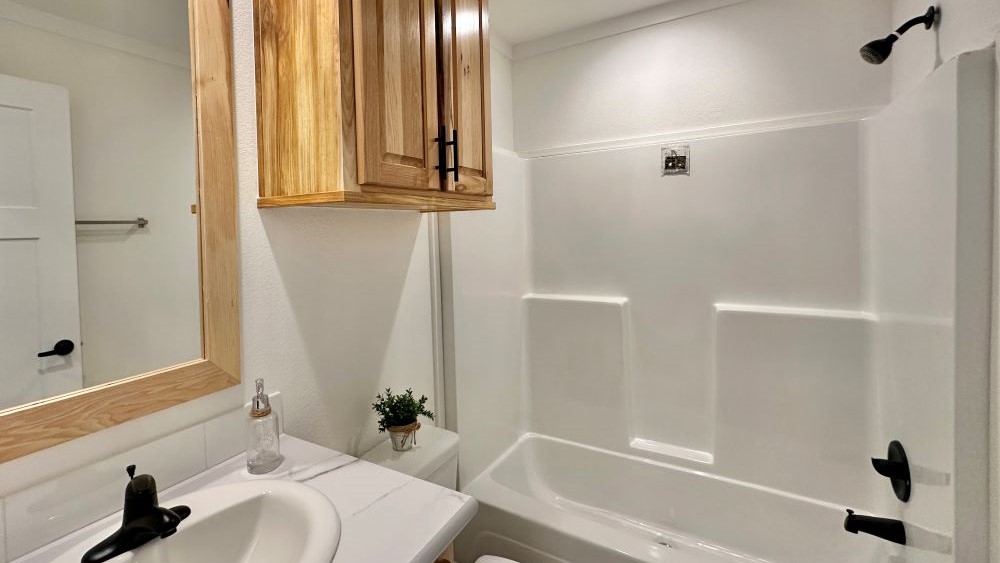 Master bedroom closet with barn doors and built-in storage in The Stealth model.
